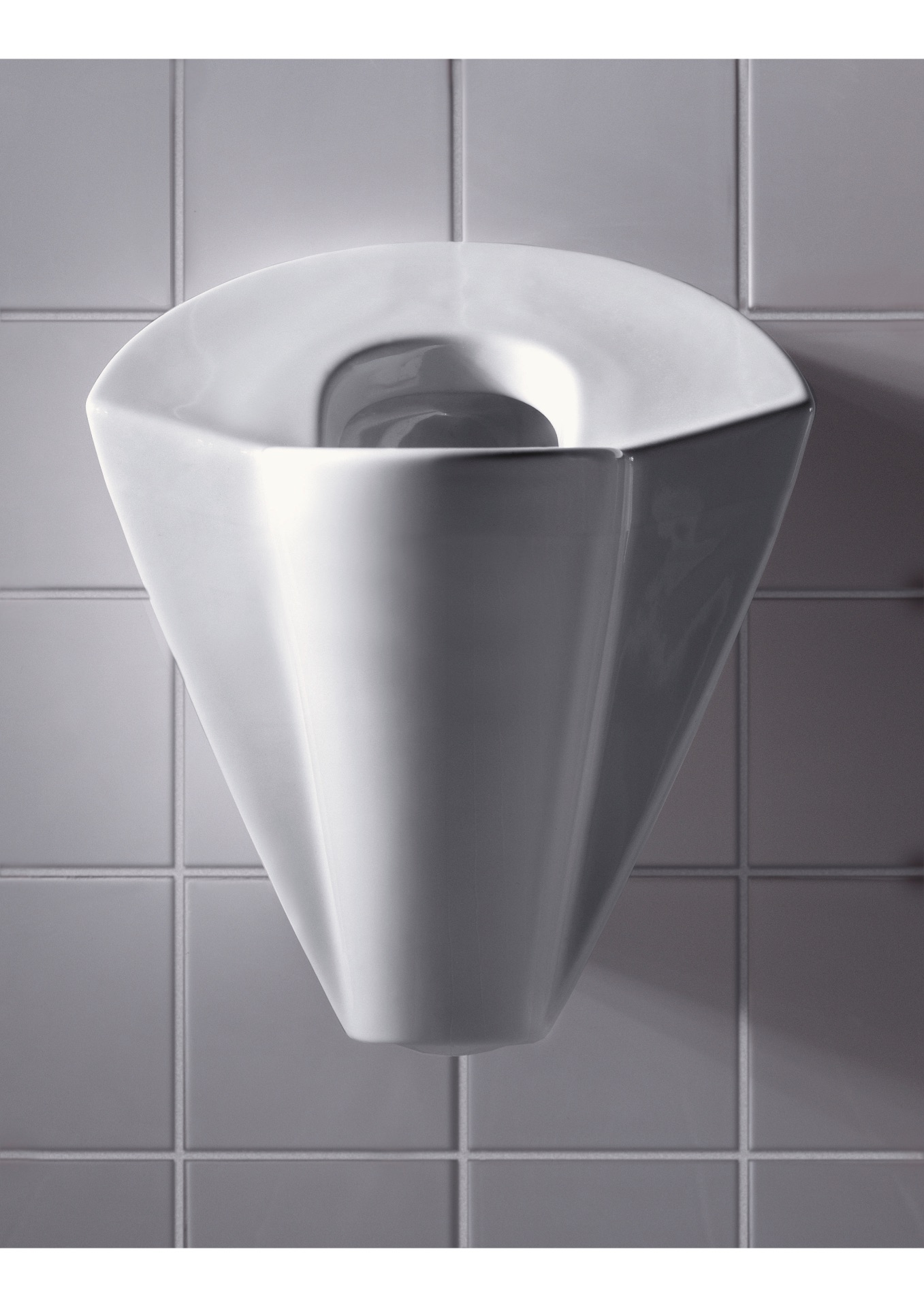 lady p female urinal in white ceramic on white tiled wall.